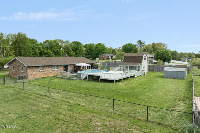 300 Wimberly Way, Bristol, TN 37620 - exterior space with an outbuilding, a fenced backyard, a shed, a lawn, and a deck