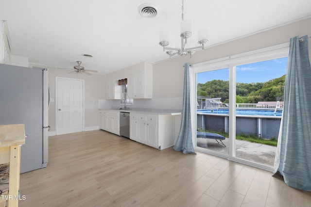 300 Wimberly Way, Bristol, TN 37620 - kitchen with white cabinetry, light wood-style floors, appliances with stainless steel finishes, and light countertops