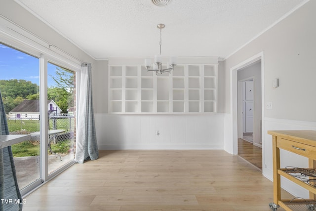 300 Wimberly Way, Bristol, TN 37620 - unfurnished dining area featuring a textured ceiling, a chandelier, ornamental molding, light wood finished floors, and built in shelves