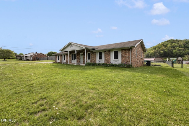 300 Wimberly Way, Bristol, TN 37620 - single story home with brick siding, a porch, fence, and a front lawn