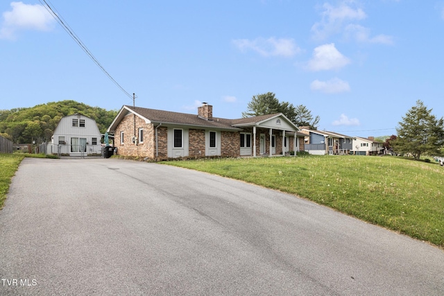 300 Wimberly Way, Bristol, TN 37620 - single story home with a front lawn, driveway, brick siding, and a chimney