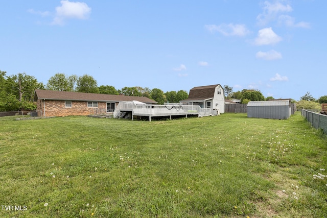 300 Wimberly Way, Bristol, TN 37620 - view of yard featuring a deck, a storage unit, a fenced backyard, and an outdoor structure