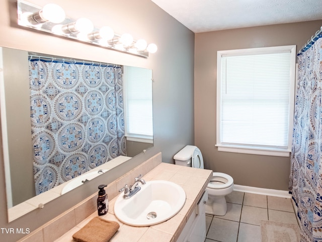 bathroom featuring tile patterned flooring, vanity, and toilet