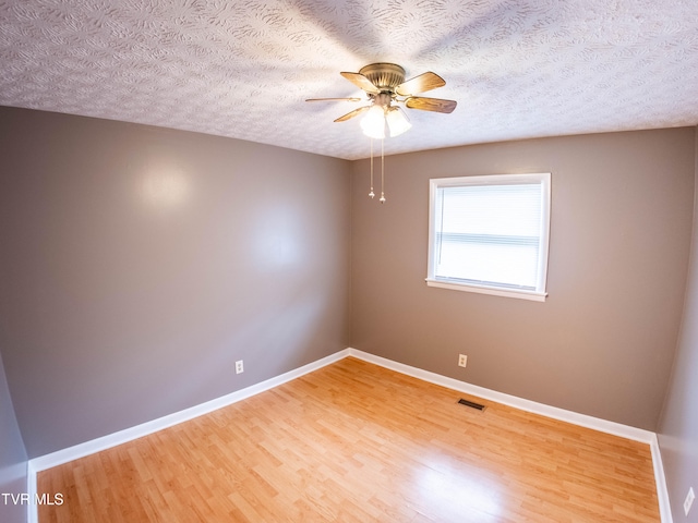 unfurnished room featuring ceiling fan, a textured ceiling, and hardwood / wood-style floors