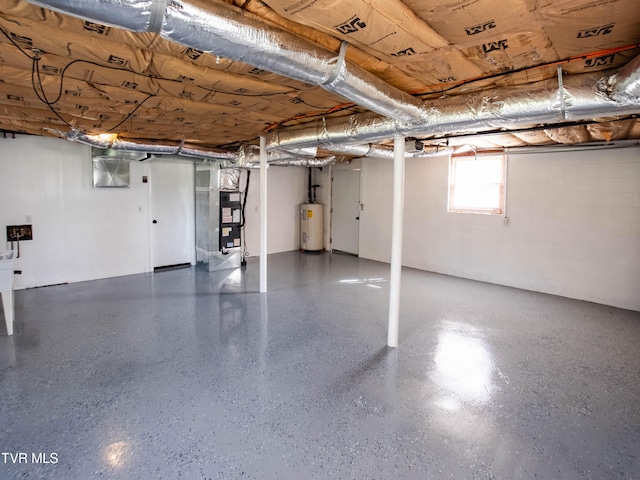 basement featuring heating unit and electric water heater