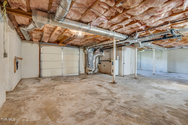 garage featuring water heater and heating unit