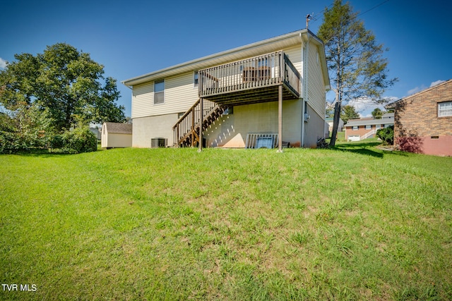 back of house with a lawn, a wooden deck, and central AC