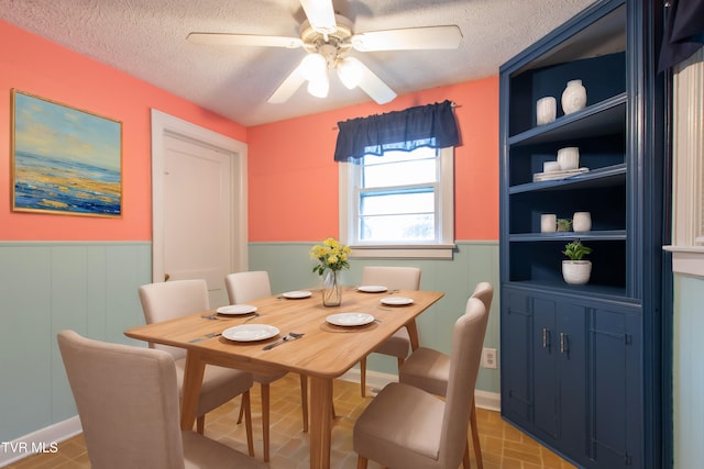 dining space featuring built in shelves, a textured ceiling, and ceiling fan