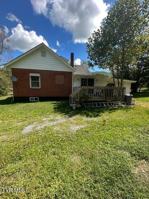 rear view of property with a lawn