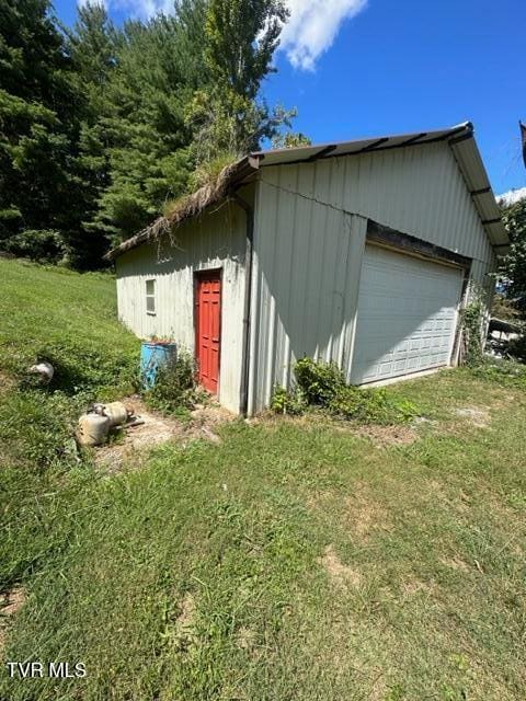 exterior space with a garage and a yard