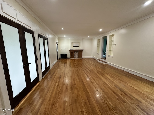 1357 Watauga St, Kingsport, TN 37660 - unfurnished living room featuring crown molding, wood finished floors, french doors, built in features, and recessed lighting
