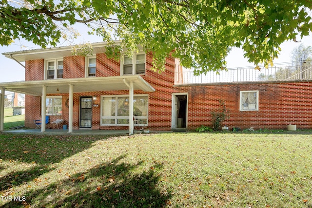 back of house featuring a patio and a yard