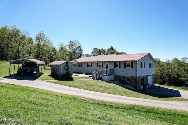 bi-level home with a carport, a storage shed, a front yard, and a garage