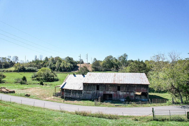 exterior space with a rural view and an outbuilding