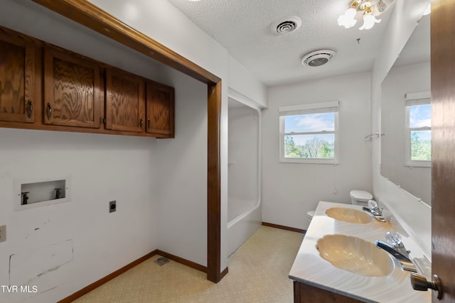 full bathroom with vanity, toilet, plus walk in shower, and a textured ceiling