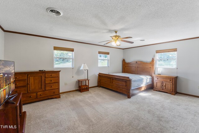 carpeted bedroom featuring multiple windows, ceiling fan, and a textured ceiling