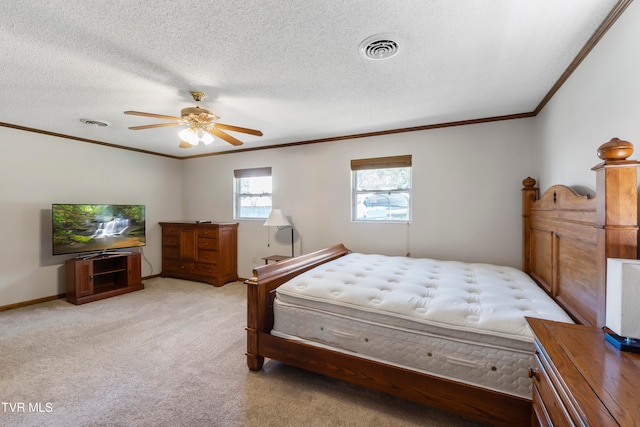 carpeted bedroom with crown molding, ceiling fan, and a textured ceiling