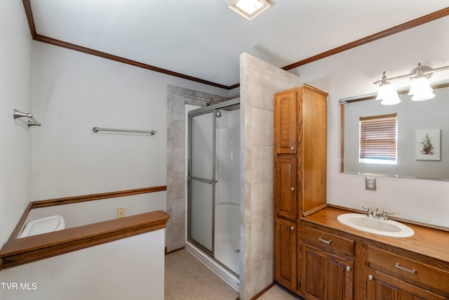 bathroom with ornamental molding, a shower with door, and vanity