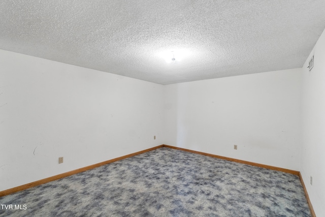 carpeted spare room featuring a textured ceiling