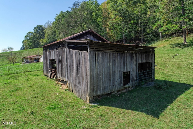 view of outbuilding featuring a lawn