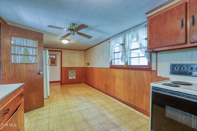 kitchen with wooden walls, white appliances, and ceiling fan