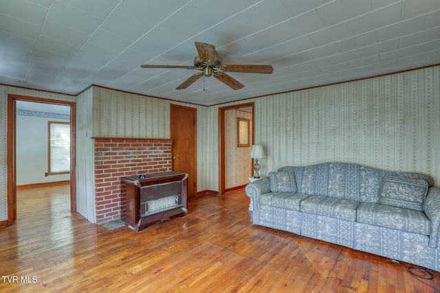 living room with ceiling fan, ornamental molding, and hardwood / wood-style floors