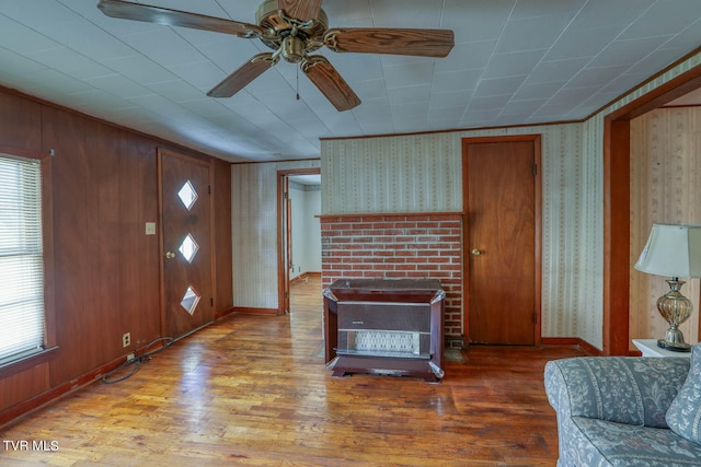 entrance foyer featuring wood walls, hardwood / wood-style floors, ceiling fan, and a wealth of natural light