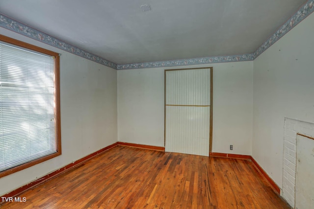 unfurnished room with wood-type flooring