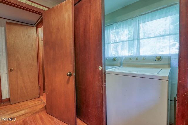 laundry room featuring light wood-type flooring and washing machine and clothes dryer