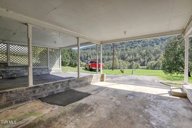 view of patio / terrace with a mountain view and a carport