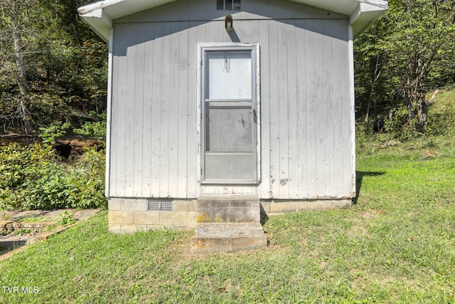 view of outbuilding with a lawn