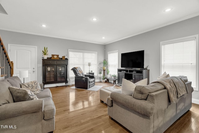 living room featuring stairs, recessed lighting, light wood-style flooring, and crown molding