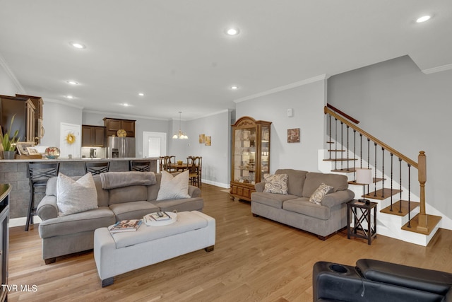 living area with stairs, light wood-type flooring, and recessed lighting