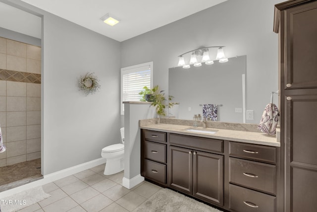 bathroom with baseboards, tiled shower, toilet, tile patterned floors, and vanity