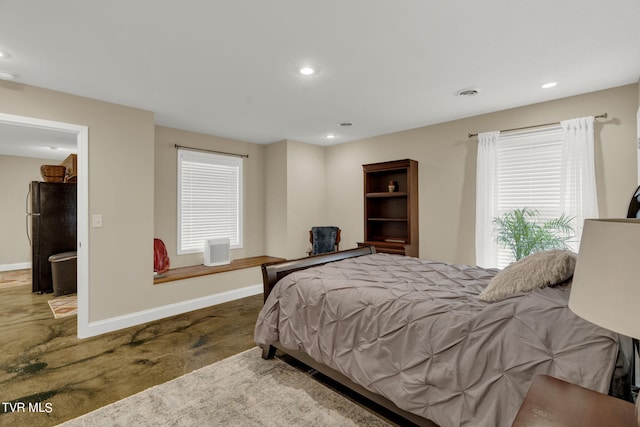 bedroom featuring freestanding refrigerator, visible vents, baseboards, and recessed lighting