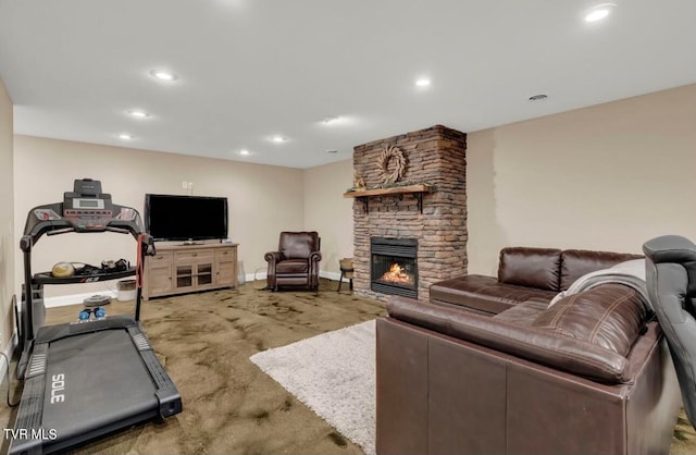 living area featuring a fireplace, baseboards, and recessed lighting