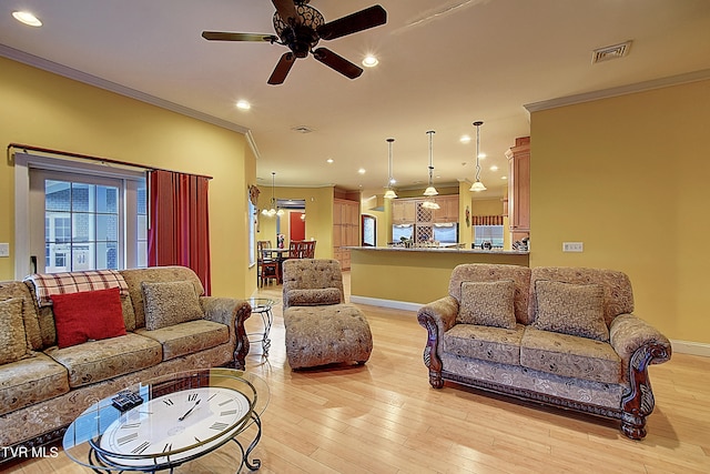 living room featuring ornamental molding, light hardwood / wood-style floors, and ceiling fan with notable chandelier