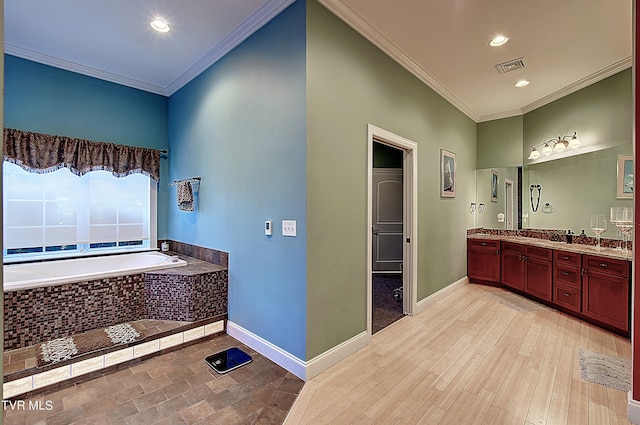 bathroom with vanity, tiled bath, ornamental molding, and wood-type flooring