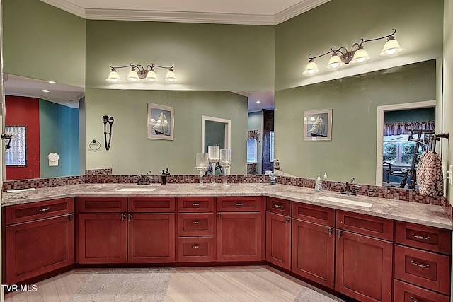 bathroom featuring hardwood / wood-style flooring, vanity, and crown molding