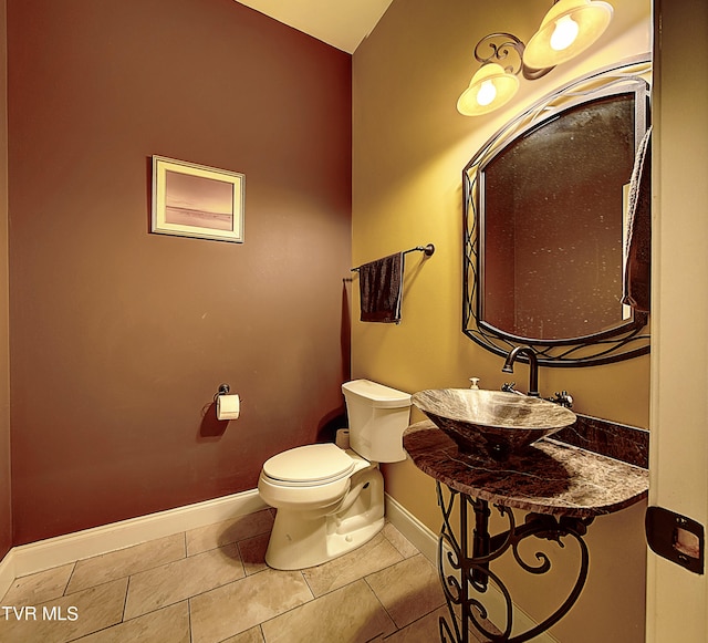 bathroom featuring tile patterned flooring, sink, and toilet