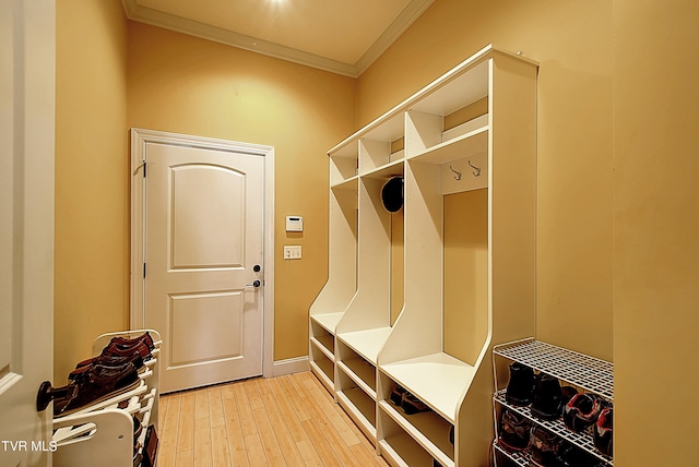 mudroom with crown molding and hardwood / wood-style floors