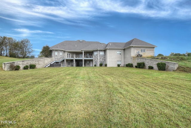 back of property featuring a lawn