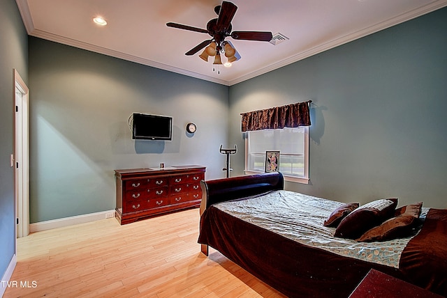 bedroom with crown molding, light hardwood / wood-style floors, and ceiling fan