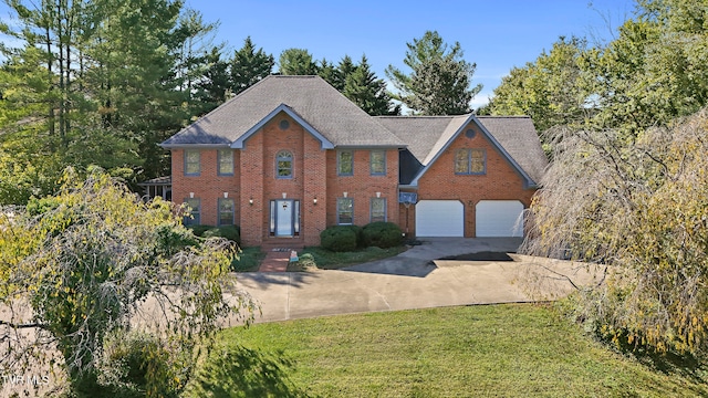 view of front of property with a front yard and a garage