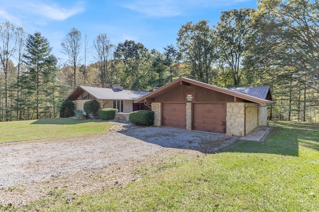 single story home featuring a garage and a front lawn