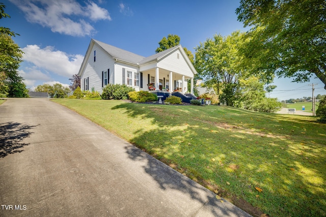 view of front of house with a front yard and a porch