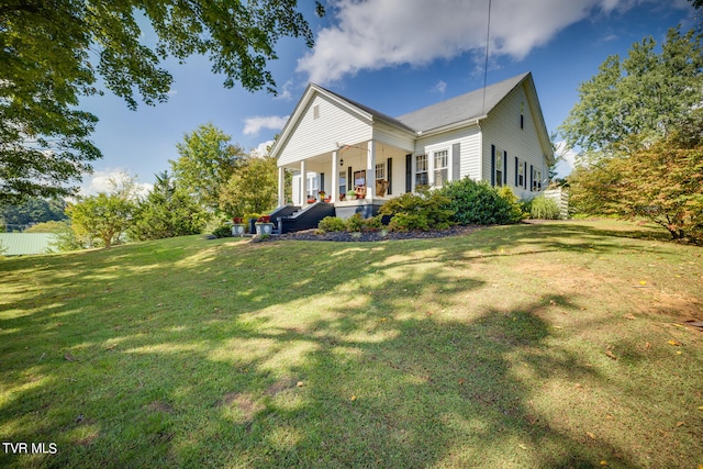 back of house with a lawn and a porch