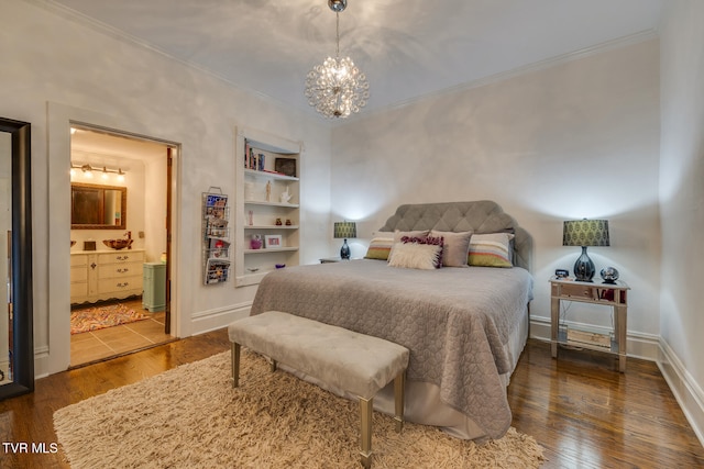 bedroom featuring an inviting chandelier, connected bathroom, ornamental molding, and dark hardwood / wood-style flooring