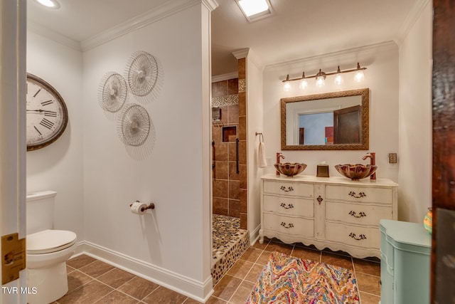 bathroom with ornamental molding, tiled shower, vanity, and toilet