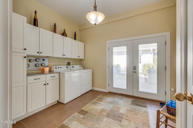 clothes washing area featuring french doors, cabinets, and washing machine and dryer